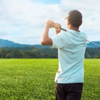 Golfer finishing his driver swing