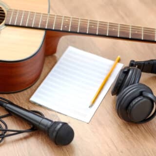 Guitar, music book, microphone and headphones